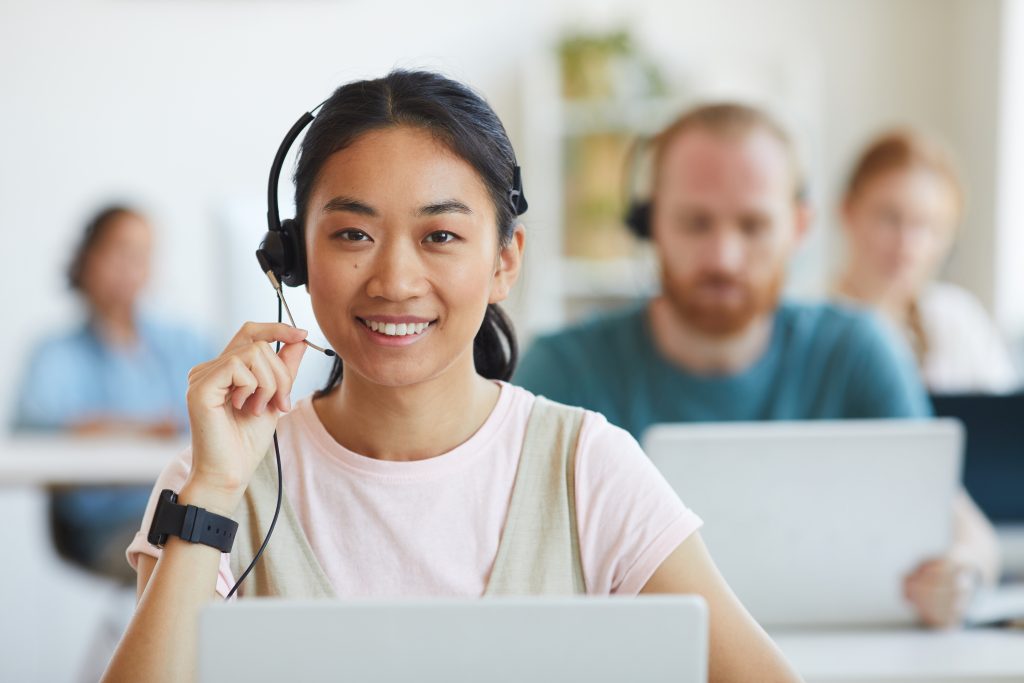 Young woman with headset smiling