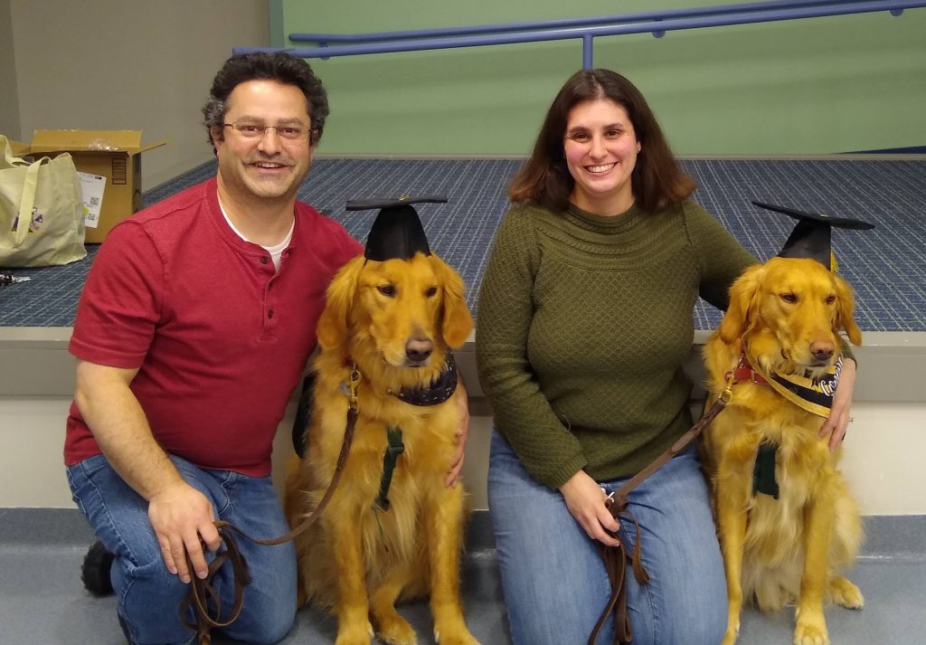 man and woman with dogs wearing hats