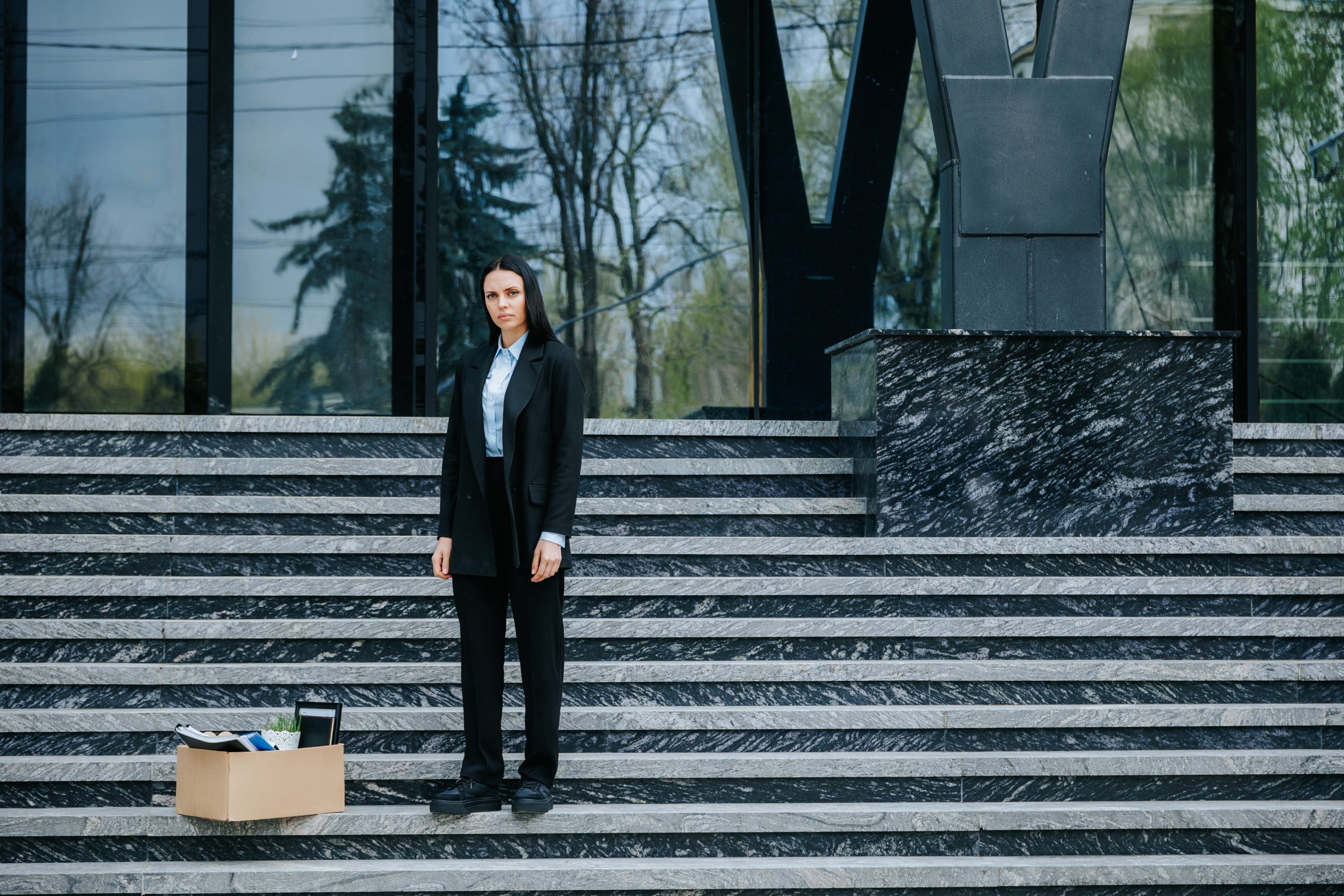 woman who was laid off standing on steps